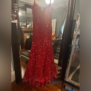 red sequin gown.  Tagged size 8.  Altered to fit size 6.  All material intact